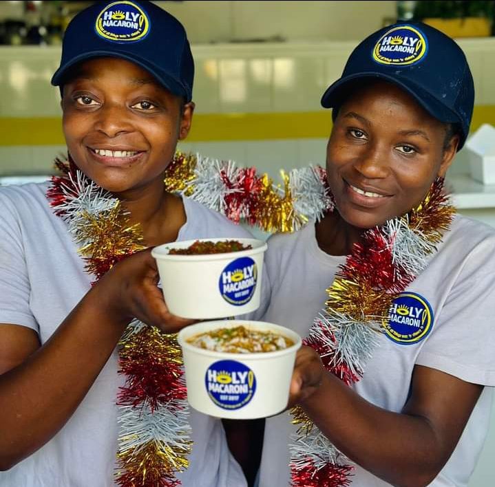 Holy Macaroni team holding mac and cheese bowls